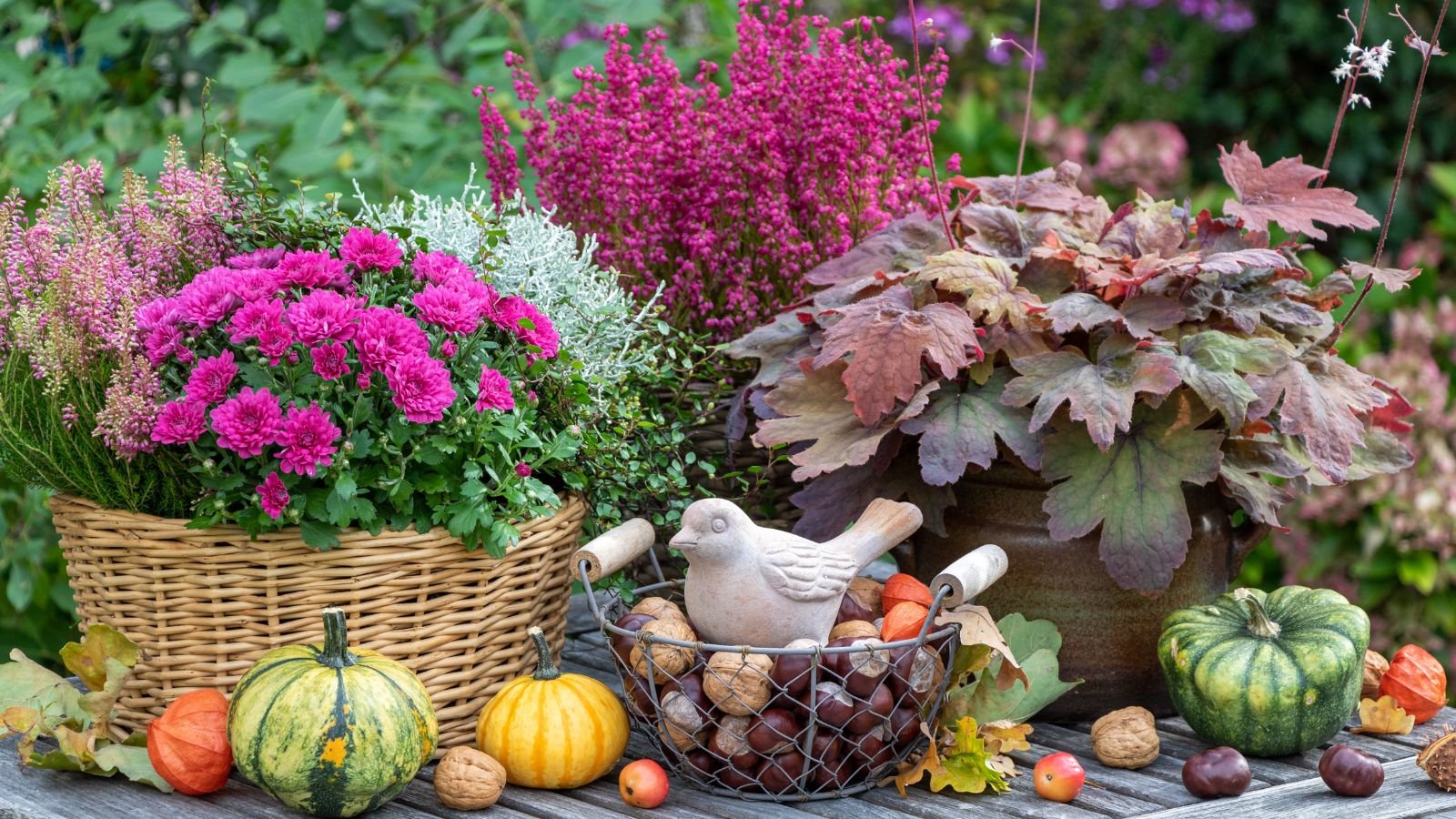 A shot of various autumn crops placed on different rustic baskets and pots on top of a wooden surface in a cozy outdoor area.