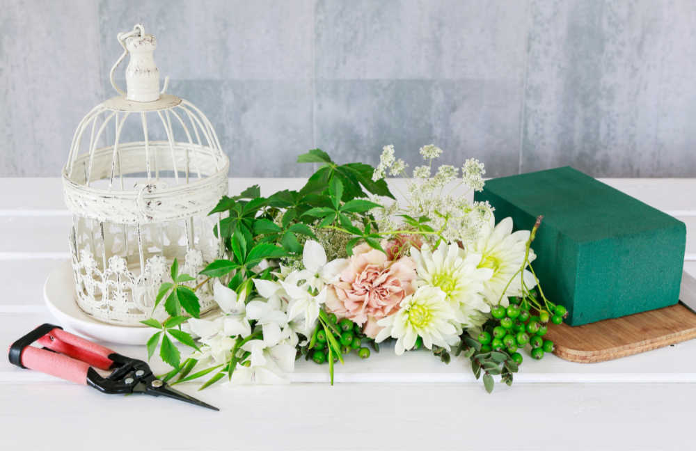 Supplies for arranging silk flowers in a bird cage.