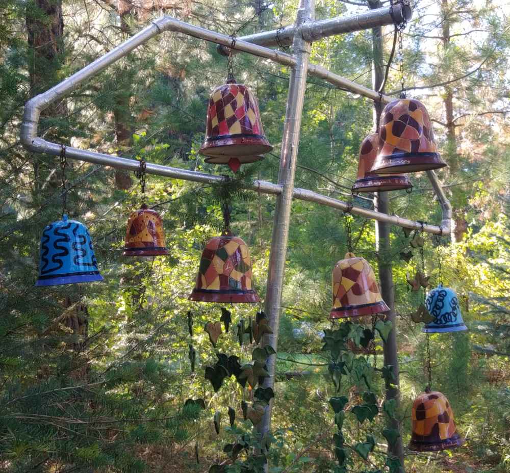 Colorful bells hanging in a tree.