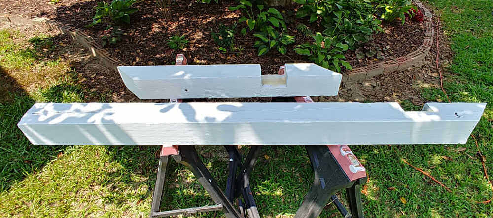 Two pieces of 4 x 4 timber painted white with lap joint.